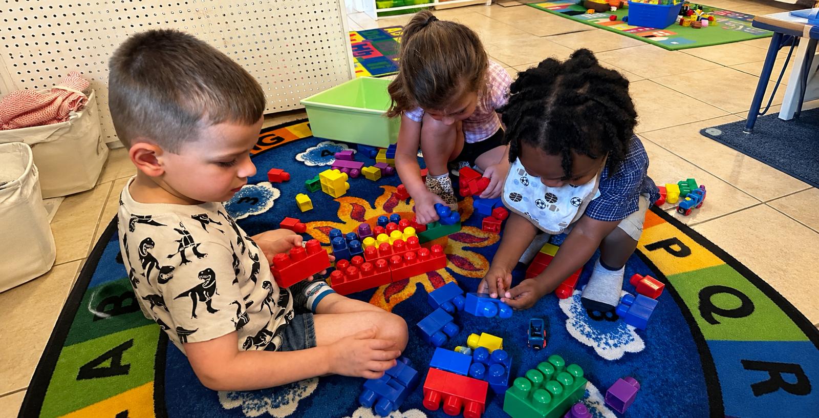 Toddlers building with blocks in the classroom